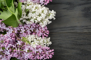 purple and white lilac flower on old oak table top view with