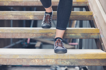 Young woman walking down wooden steps