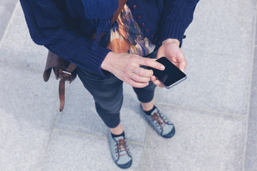 Young woman using smart phone outside