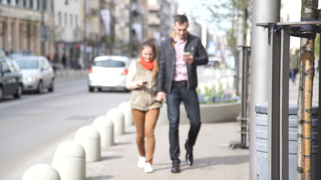 woman and man with mobile phone in the city