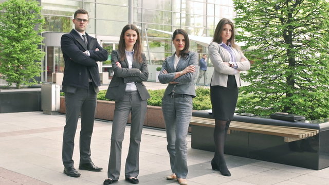 Businesspeople standing and doing serious look to the camera
