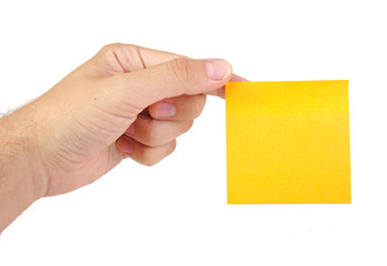 Hand holding a yellow notepaper or postit isolated on a white
