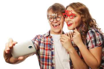smiling couple with smartphone, selfie and fun. 