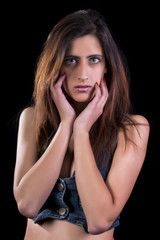 Close up view of a sensual young woman in jean wear.