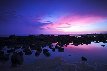 Fototapeta na wymiar Sunset sky rocky shoreline