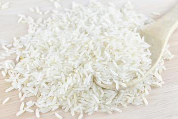 rice in wooden Spoon on rice and wooden background