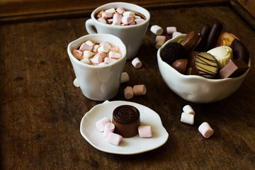 Belgian chocolate in a white bowl on a wooden table