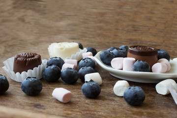 Fototapeta na wymiar Belgian chocolate and marshmallow on a wooden table