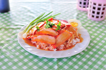 thai food is name rice red pork sauce