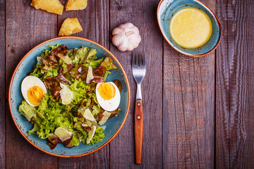 Fresh salad with egg and parmesan cheese
