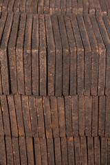 Close view of a pile of traditional mud bricks production.