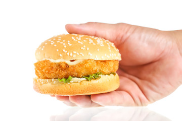 Hand holds big hamburger on white background
