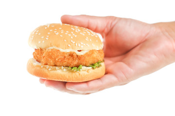 Hand holds big hamburger on white background