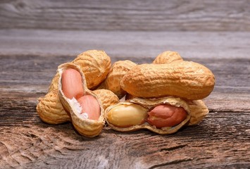 Peanuts in shells on wooden background