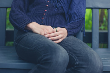 Young woman sitting on bench in nature