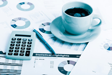 Close of business workplace with financial reports and office st