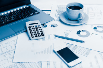 Close of business workplace with financial reports and office st