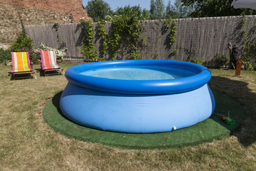 blue rubber pool on the grass for children