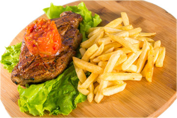 Grilled steak, french fries and lettuce
