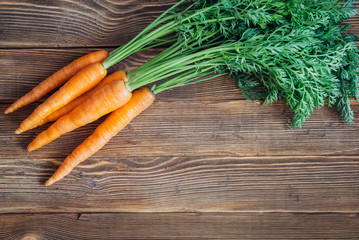 Fresh carrot on rustic wooden background