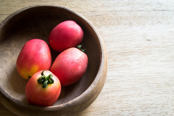 tomatoes in  wooden bowl