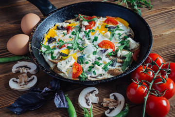 Eggs with vegetabls on rustic wooden background