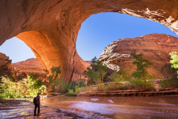 A hiker under Jacob Hamblin Arch in Coyote Gulch, Grand Staircase-Escalante National Monument.