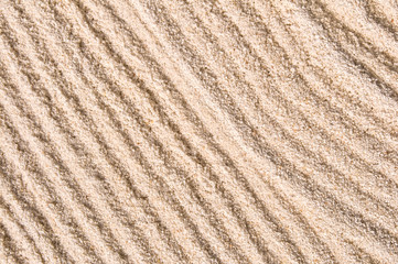 Fototapeta na wymiar Raked sand of a japanese garden, close-up