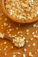 Oatmeal in a bowl with wooden spoon