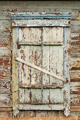 Old wooden window with closed shutters