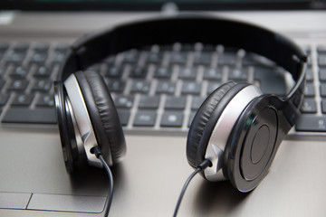 Obraz na płótnie Canvas Headphones on laptop keyboard