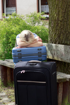 crying woman with big suitcase