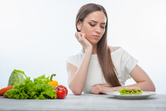 Woman is choosing between healthy and unhealthy food