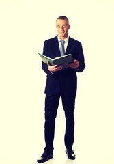 Businessman reading his note book
