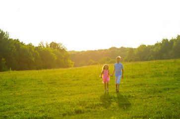 Brother holding sister's hand.