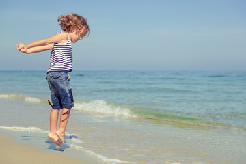little boy standing on the beach