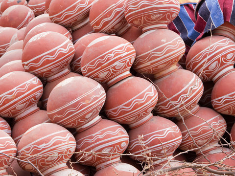 Pots for sale stacked at a roadside market in Rajasthan, India