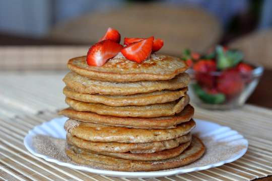 Stack of sweet pancakes with strawberries and cinnamon sugar 