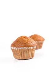 Two brown banana muffin in paper cupcake holder isolated on whit