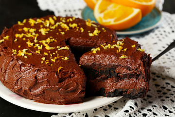 Chocolate cake with oranges on table, close-up