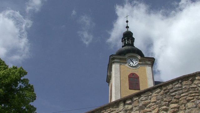 Church tower with bells beating.