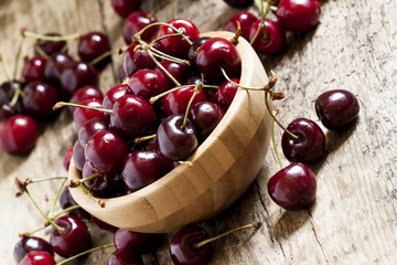 Fresh cherries in a wooden bowl, selective focus