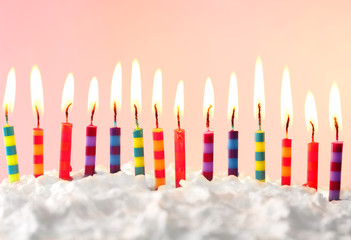 Birthday cake with candles on color background