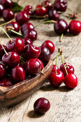 Fresh  cherries in a wooden bowl in the shape of a heart, select