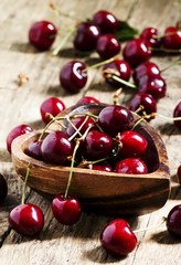 Fresh  cherries in a wooden bowl in the shape of a heart, select