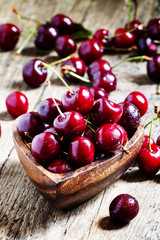 Fresh  cherries in a wooden bowl in the shape of a heart, select