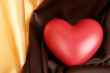 Red heart on fabric background