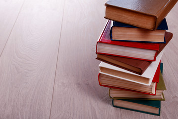 Stack of books on wooden background
