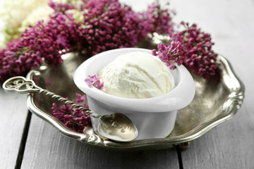 Beautiful composition with tasty ice cream and lilac flowers