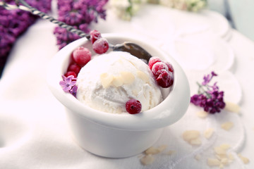 Beautiful composition with tasty ice cream and lilac flowers